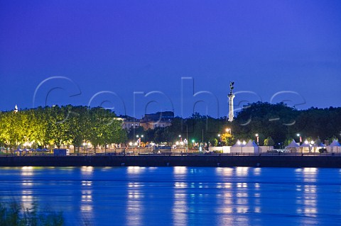 Monument aux Girondins and lights of Quai Louis XVIII reflecting in the Garonne river at dusk  Bordeaux Gironde France