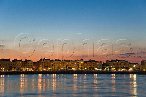 Lights of Quai des Chartrons reflecting in the Garonne river at dusk Bordeaux Gironde France