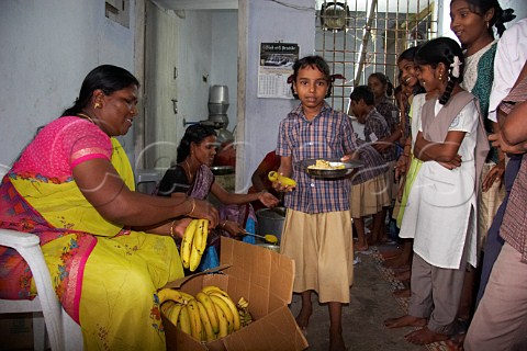 Women help provide a meal for the children at the Compassion Ayanavaram Child Development Centre in the India Pentecostal Church of God IPC Thiruvalluvar Nagar Ayanavaram Chennai Madras India