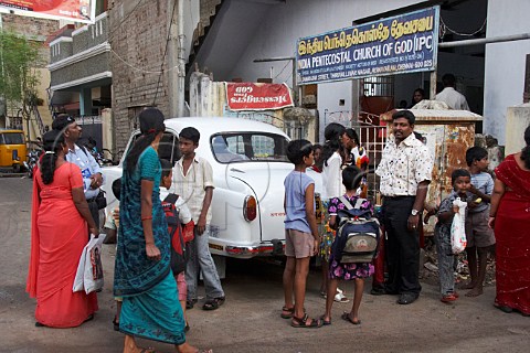 Locals congregating outside the India Pentecostal Church of God IPC Thiruvalluvar Nagar Ayanavaram Chennai Madras India