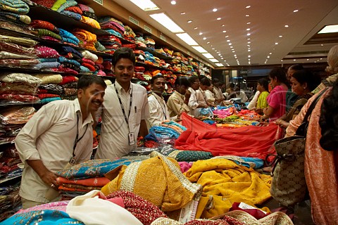 Indian men selling fabrics in Pothys textile store Panagal Park TNagar Chennai Madras Tamil Nadu India