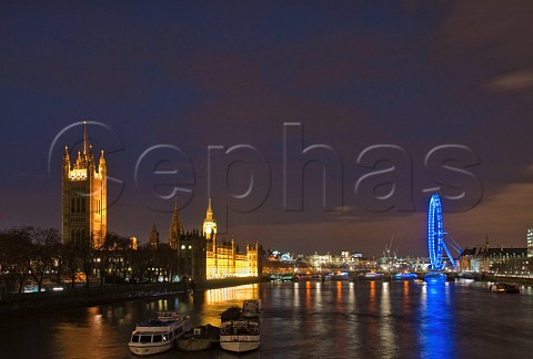 Houses of Parliament and London Eye reflecting in the River Thames at night Westminster London