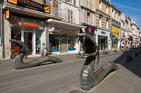 Bronze dragons marking road edges in a shopping street in Niort DeuxSvres France
