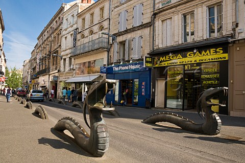Bronze dragons marking road edges in a shopping street in Niort DeuxSvres France