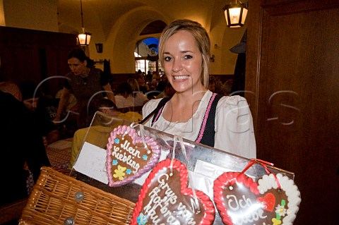 Barmaid selling heartshaped valentines cakes in the Hofbruhaus Munich Bavaria Germany