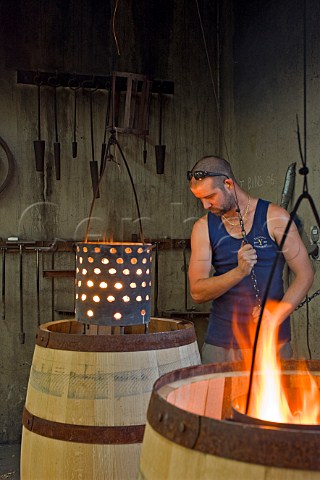 Shaon Gibson toasting new oak barrels in the cooperage of Yalumba Winery  Angaston South Australia  Barossa Valley