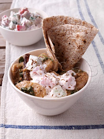 Chicken and spinach curry with raita and naan