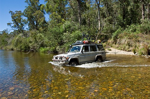 4wd car crossing Murray River Davies Plain Track Alpine National Park Victoria Australia