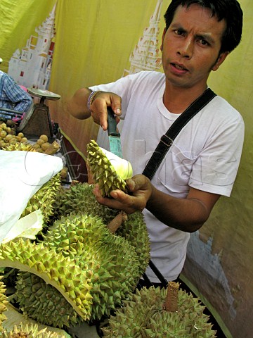 Cutting durian fruit in a street market Bangkok Thailand