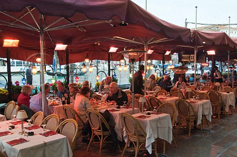 Open air restaurant seating overlooking the Grand Canal Riva del Vin Rialto Venice Italy