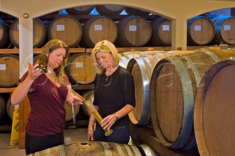 Winemaker Luisa Ponzi with marketing director and sister Maria Ponzi Fogelstrom in barrel cellar at Ponzi Vineyards winery   Beaverton Oregon USA  Willamette Valley