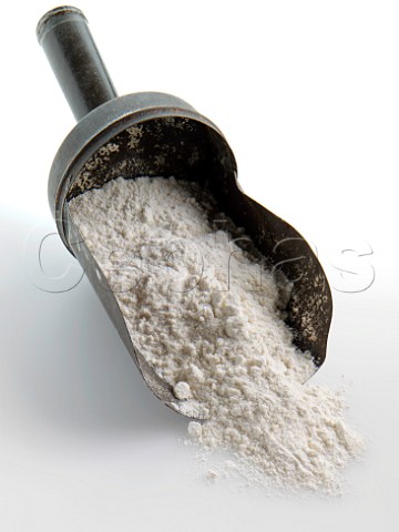 Flour spilling from an old tin scoop