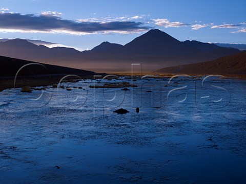Dawn over semifrozen lake in the Altiplanica near the Tatio Geysers at an altitude of over 4000 metres in the Atacama Desert Chile