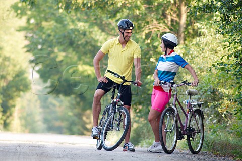 Couple cycling on country road