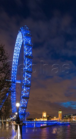 London Eye observation wheel overlooking the   Parliament buildings and River Thames at dusk   London