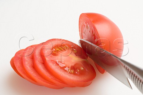 Slicing an organic vine tomato