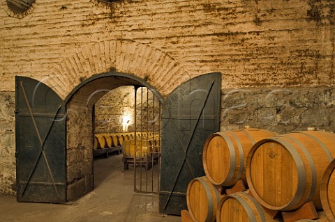 Oak wine barrels in brick and limestone display cellar at Cousio Macul Santiago Maipo Valley Chile  Maipo Valley