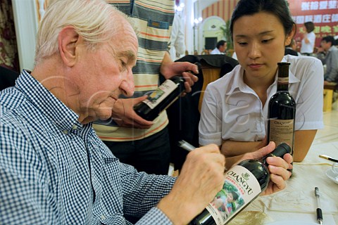 Robert Tinlot signing wine bottles in one of the restaurants at Chateau Changyu AFIP Global winery Ju Gezhuang Beijing Miyun County China