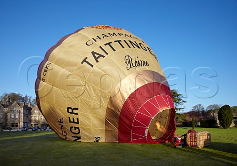 Inflating the Taittinger hotair balloon in the grounds of Bibury Court Hotel Gloucestershire England