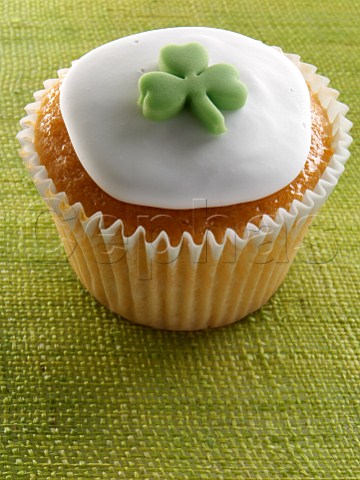 Cupcake with a green shamrock on top of the white icing