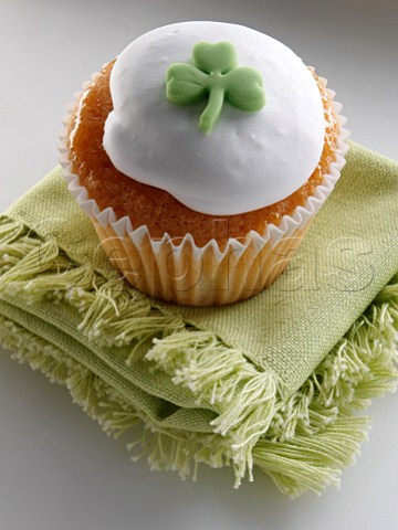 Cupcake with a green shamrock on top of the white icing