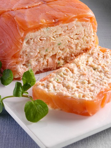 A whole salmon terrine with a slice in front