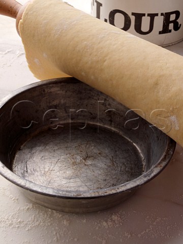 Shortcrust pastry rolled out going into a pie tin