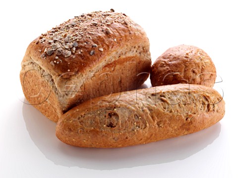 Multigrain loaf and rolls on a white background