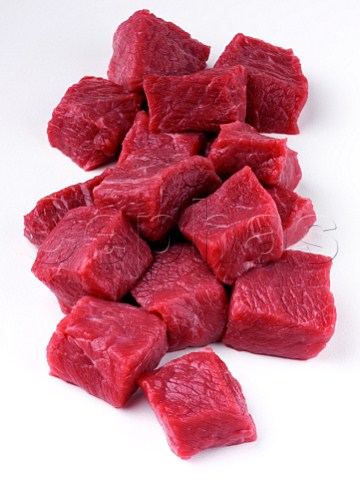 Cubes of raw lamb on a white background