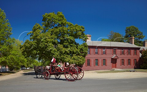 Horsedrawn carriage passing the Peyton Randolph House on Nicholson Street  Colonial Williamsburg Virginia USA