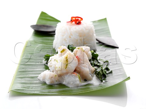 Individual portion of Fish Amok on a palm leaf Cambodian cuisine