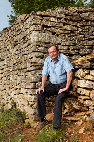 Bruno Clair sitting on a wall of limestone the stones for which were dug from his Vaudenelles vineyard Domaine Bruno Clair MarsannaylaCte CtedOr France  Marsannay