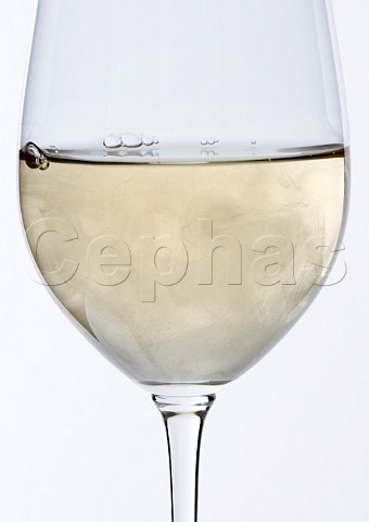 Glass of white wine which is cloudy due to a fermentation fault