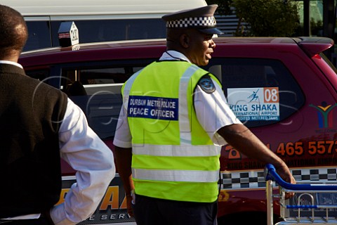 Police officer and taxi at King Shaka International Airport Durban KwaZuluNatal South Africa