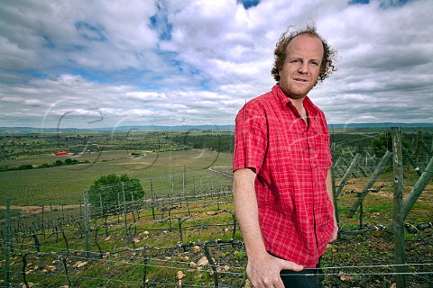 Sven Bruchfeld in Syrah vineyard of Polkura with his winery in distance Marchigue Colchagua Valley Chile