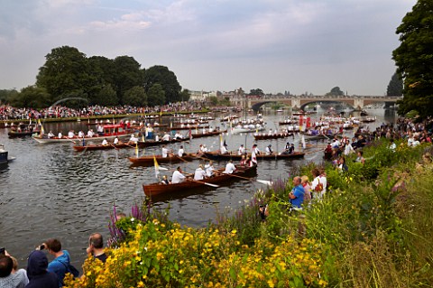 Friday 27 July 2012 Flotilla of boats on River Thames at Hampton Court Bridge waiting to follow the Olympic flame downstream to London England