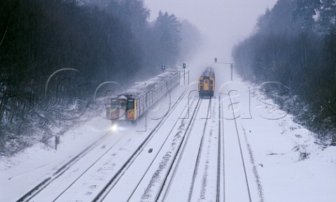 Two trains passing on snow covered tracks England