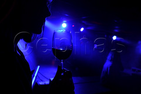 Woman with glass of red wine at a party
