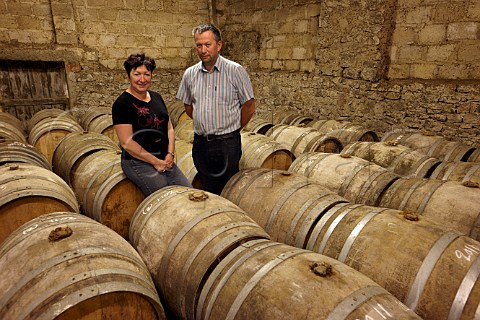 JeanChristophe and Valrie Tissot with barrels of Vin Jaune ageing in the grenier loft of  Domaine JeanLouis Tissot Les Arsures Jura France  Arbois