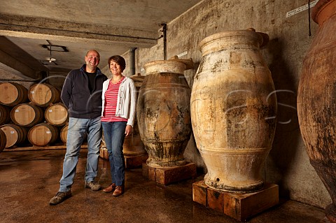 Stphane and Bndicte Tissot with amphorae used for ageing Savagnin and sometimes Trousseau in winery of Domaine Andr et Mireille Tissot MontignylsArsures Jura France  Arbois