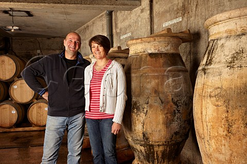 Stphane and Bndicte Tissot with amphorae used for ageing Savagnin and sometimes Trousseau in winery of Domaine Andr et Mireille Tissot MontignylsArsures Jura France  Arbois