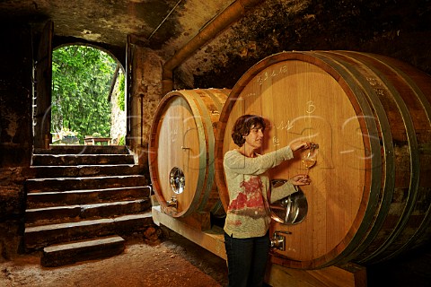 Nicole Driaux taking a sample from a foudre in cellar of Domaine de Montbourgeau LEtoile Jura France  Ltoile