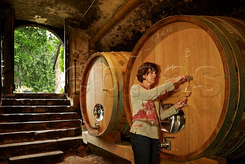 Nicole Driaux taking a sample from a foudre in cellar of Domaine de Montbourgeau LEtoile Jura France  Ltoile