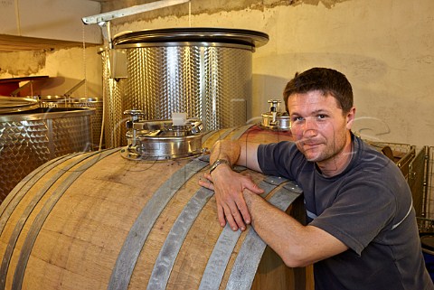 Patrice Bguet with barrel which he uses for whole berry fermentation Domaine HughesBguet Mesnay Jura France Arbois