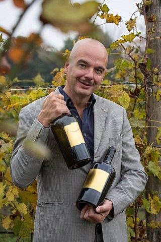 Gianluca Bisol with two bottles of Venissa With a label of gold leaf it is made from Dorona grapes from the Venissa vineyard of Bisol on the island of Mazzorbo Venice Lagoon Veneto Italy