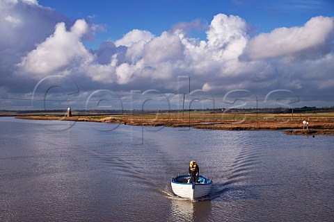 Man and dog in boat on the River Blyth Southwold Harbour Suffolk England