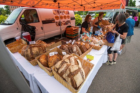 Selling freshly baked bread at the Cherry Creek Farmers Market Denver Colorado USA