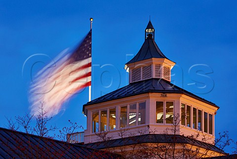 Stars and Stripes flying over the Carriage House of Trump Winery at dusk Charlottesville Virginia USA