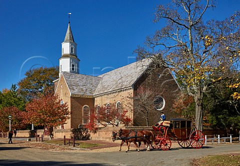 Horsedrawn carriage passing Bruton Parish Church Colonial Williamsburg Virginia USA