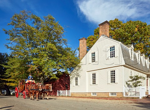 Horsedrawn carriage and traditional wooden building Colonial Williamsburg Virginia USA